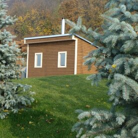Solid fuel sauna house